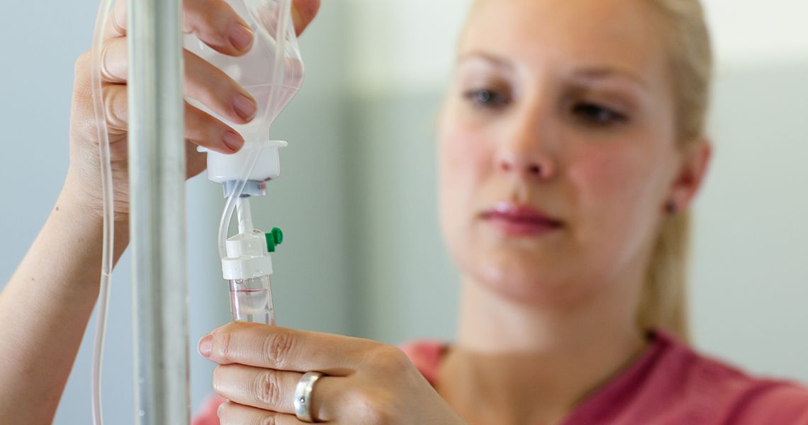 Provider setting up an IV bag