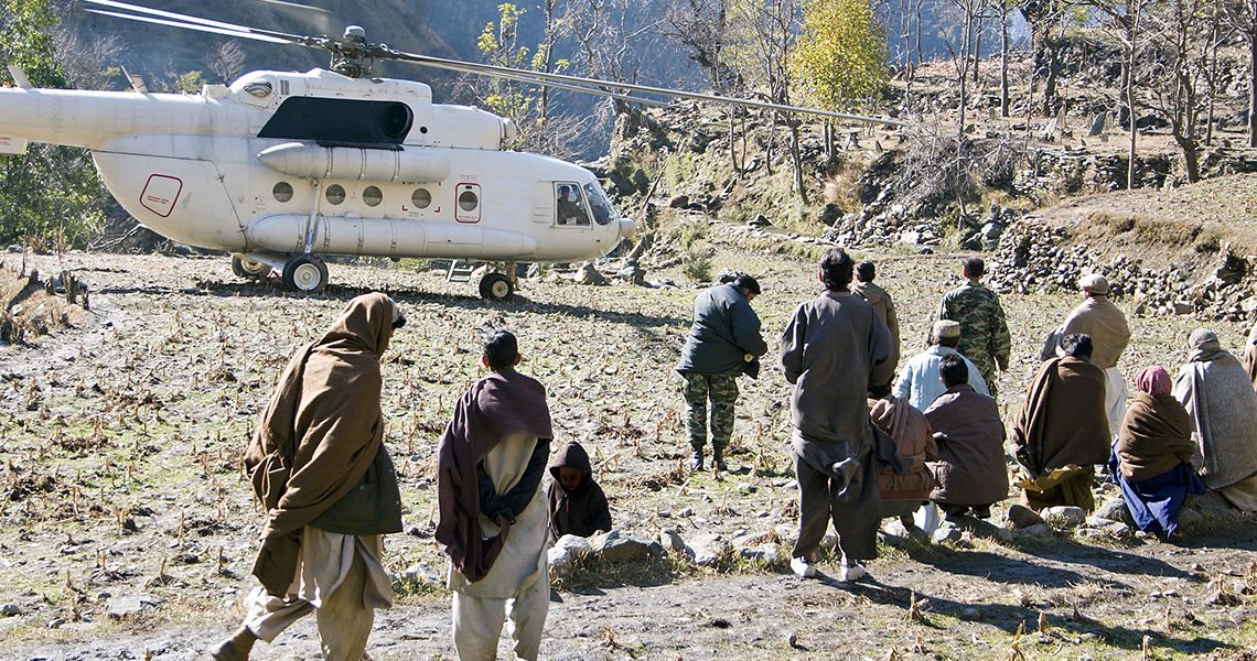 Relief helicopter landing in a desert